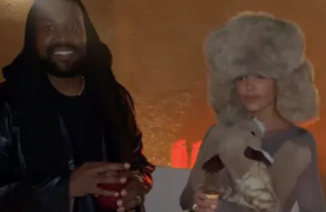 Bianca Censori in a fur hat and a plush toy and Kanye West at a party in Dubai