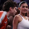 Timothée Chalamet and Kylie Jenner dressed as couples at a basketball game.