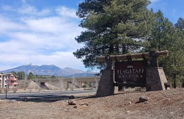 View of Flagstaff, Arizona with the snow-dusted San Francisco Peaks rising behind the town