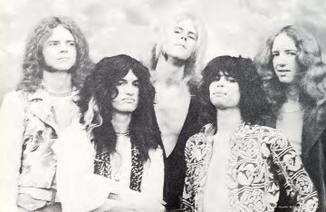 Aerosmith band members posing together in a promotional photo