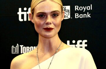 Actress Elle Fanning poses at a film screening in a stylish outfit