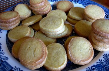 Round cardamom shortbread cookies arranged on a plate