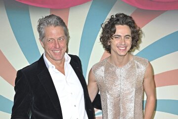 Timothee Chalamet in a transparent top and Hugh Grant and his wife at the premiere of the film "Wonka" in Paris