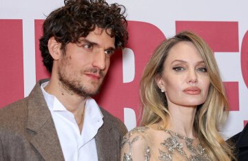 "Alone since her divorce from Brad Pitt." Angelina Jolie is not dating Louis Garrel.