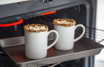 Two mugs of hot cocoa on a tray