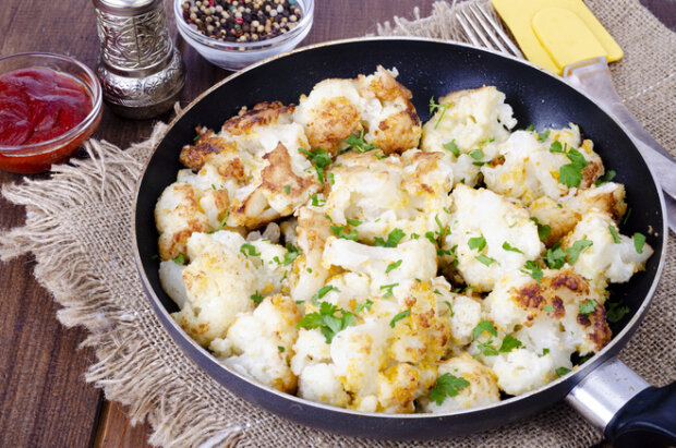 Cauliflower in batter in a frying pan