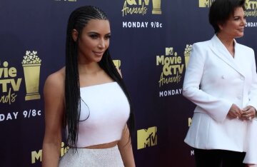 Kim Kardashian and Kris Jenner posing together at an awards event