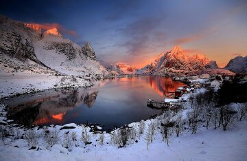 Sunrise over the red fishing cabins and fjord at Reine in the Lofoten archipelago, Norway
