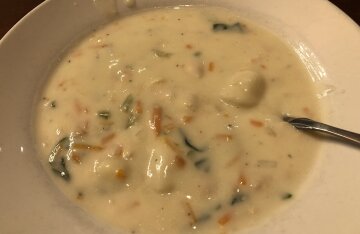 A bowl of creamy chicken and gnocchi soup with gnocchi and chicken visible