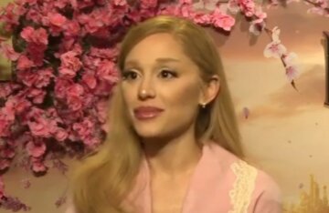 Ariana Grande posing at a Wicked promotional event