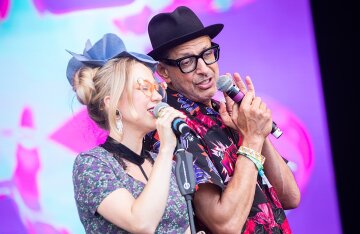 Jeff Goldblum on stage at Glastonbury Festival in a patterned suit