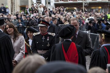 Catherine, Duchess of Cambridge, waves to crowds during a visit to Market Square in Cambridge