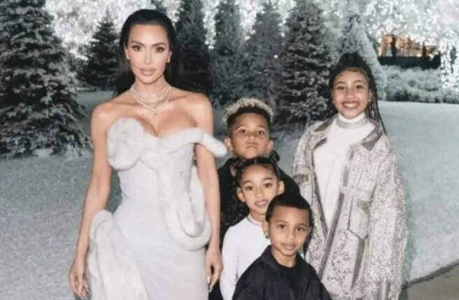 North West in Kanye West's Balmain jacket, Kim Kardashian in Mugler at a Christmas party