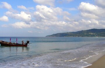 Karon Beach on Phuket island, Thailand — turquoise sea, white sand and sun loungers.
