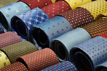 A rack of colorful patterned silk neckties