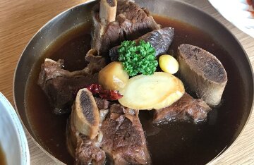 A plate of Korean braised beef short ribs, galbi-jjim, glazed and garnished