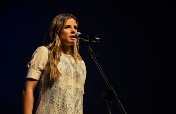 Brazilian singer-songwriter Giulia Be performing on stage at a concert