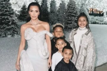 North West in Kanye West's Balmain jacket, Kim Kardashian in Mugler at a Christmas party