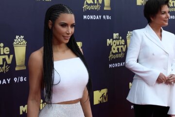 Kim Kardashian and Kris Jenner posing together at an awards event