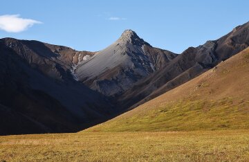 Snow-covered peak rising above the Alaska Range in Denali National Park