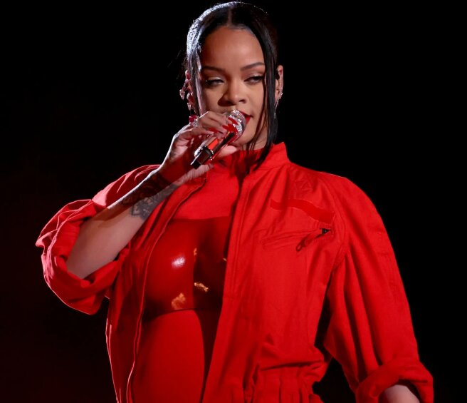 “My overalls didn’t fasten.” Rihanna says she didn't plan to announce her second pregnancy at the Super Bowl