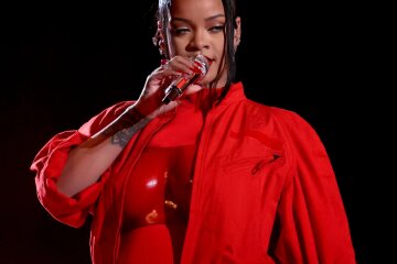 “My overalls didn’t fasten.” Rihanna says she didn't plan to announce her second pregnancy at the Super Bowl